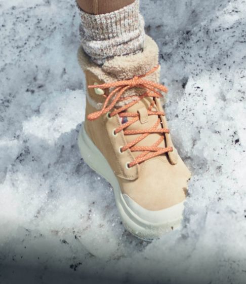 Two people outside in the snow wearing Merrell boots